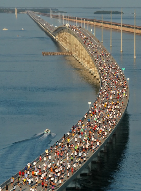 In this photo, provided by the Florida Keys News Bureau, racers approach the top of the Seven Mile Bridge near Marathon, Fla., during the Seven Mile Bridge Run. The event, across the longest of 43 bridges that help comprise the Overseas Highway in the Florida Keys, attracted 1,500 competitors. The 30th annual Seven Mile Bridge Run will be held Saturday, April 9. 