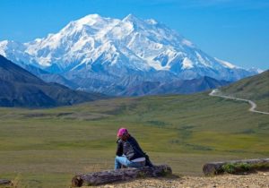 In this Monday, Aug. 3, 2015, photo provided by Holland America Line, a woman gazes at Mount McKinley in Denali National Park and Preserve. On Sunday, Aug. 30, 2015, the White House said that President Barack Obama will change the name of North America's highest peak to Denali restoring an Alaska Native name with deep cultural significance. (Andy Newman/Holland America Line)